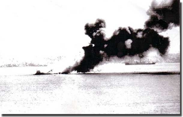 MV Macdhui burning and sinking in Port Moresby Harbour after two days of bombing by Japanese aircraft