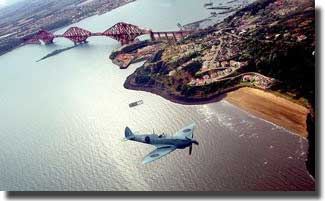 A Spitfire flies over the famous Forth Bridge in 1999 as part of a reunion of the surviving members of the Edinburgh 603 and Glasgow 602 squadrons