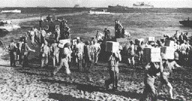 U.S. marines bring supplies ashore in the first days of the Guadalcanal campaign in August 1942.
 24 December 1942