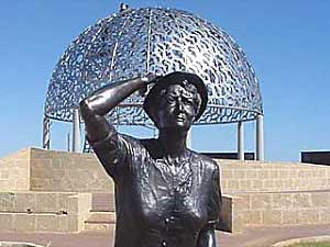 Bronze statue of Waiting Woman looking out to sea