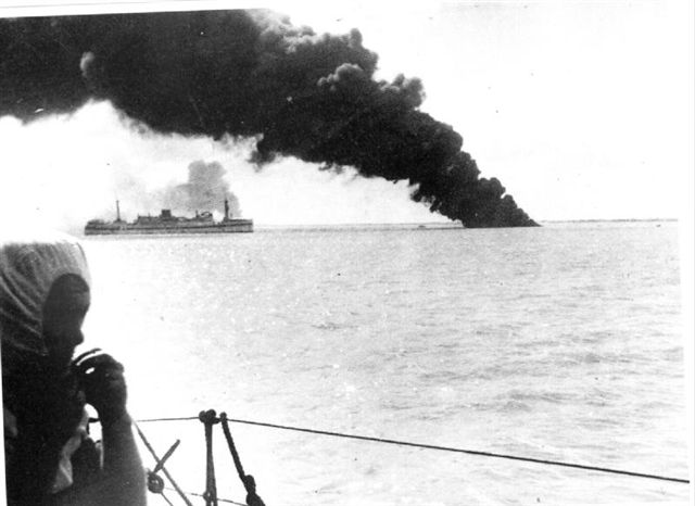 USS Peary on fire and sinking in Darwin Harbour 19th. February 1942