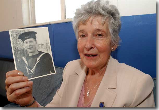 Isobel holds a photo of her Father, Jack Melville