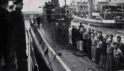 The crew of the Atlantis is seen bein addressed by Admiral Lindau, 